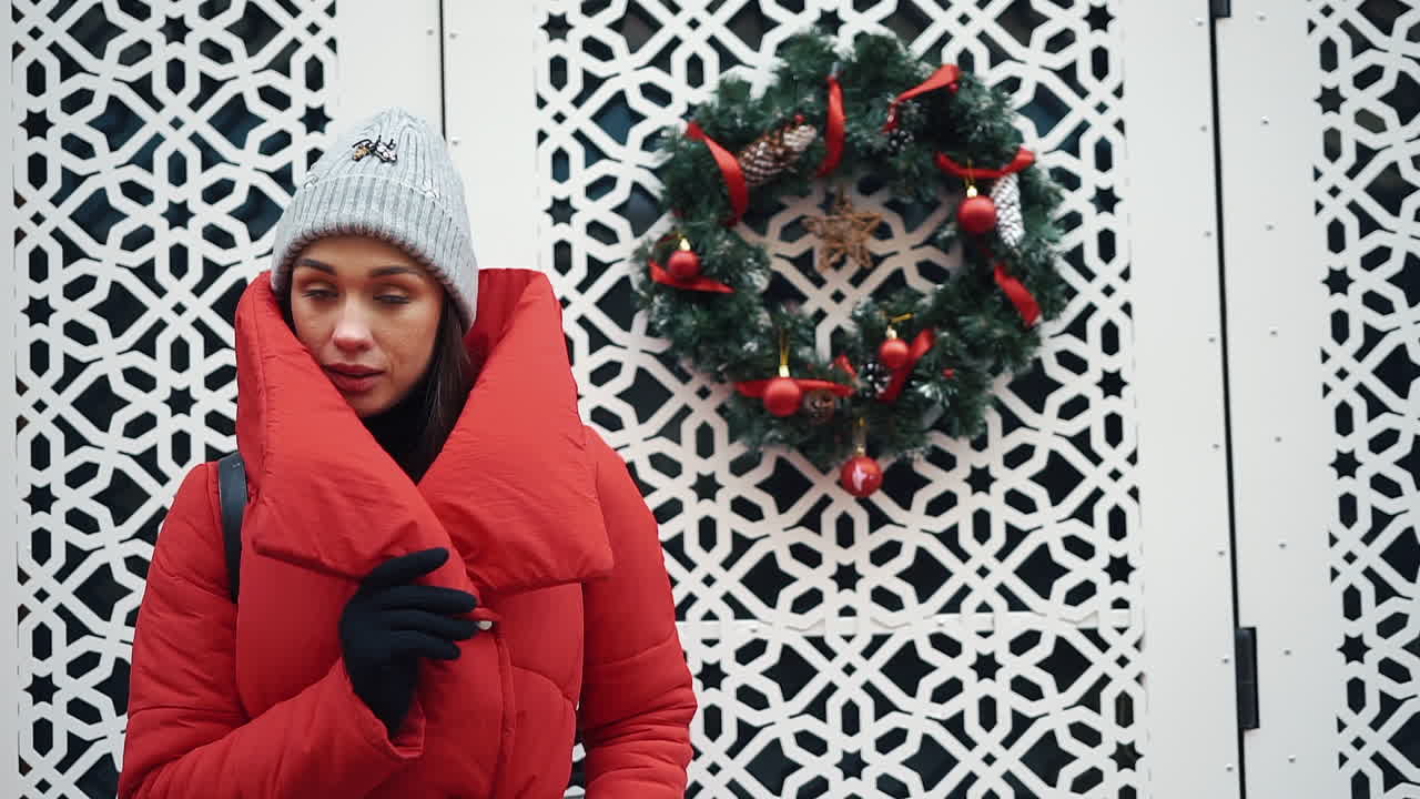 Woman in Red Puffer Jacket with Christmas Wreath