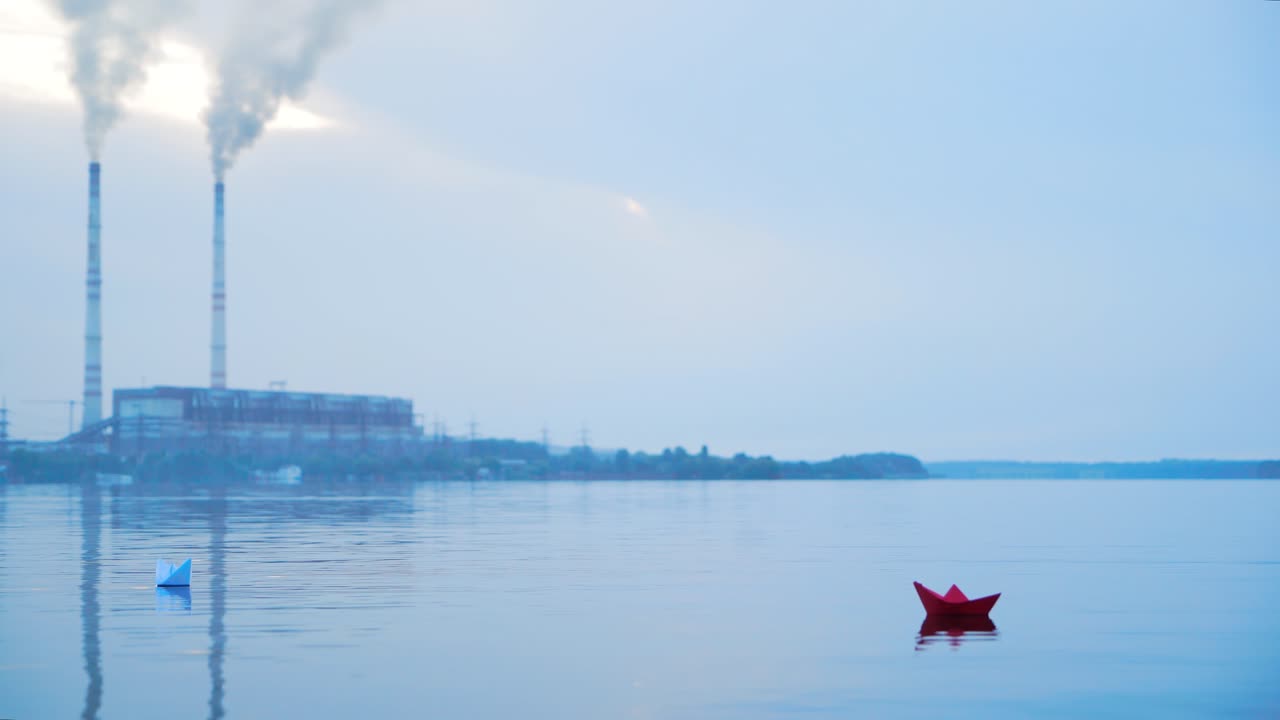 Paper boats floating in the river. Boat on the water. Beautiful sunset. Origami. River. Lake.