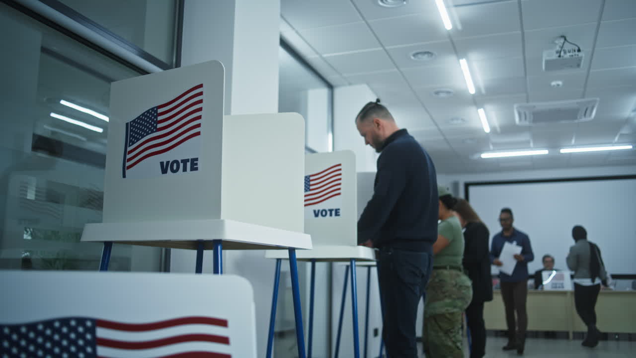 African American Man Votes in Booth in Modern Polling Station African American Man Votes in Booth in Modern Polling Station Office National Election Day in the United States Political Races of us Presidential Candidates Concept of Patriotism and Civic Duty