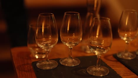 empty whiskey glasses on a wooden table