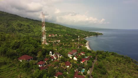 5g tower aerial drone footage with seascape ocean view over a cliff, smartphone data wireless internet lte social media global connection micro wave air pollution