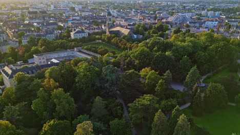 smooth aerial movement above the parc du thabor's parkside with thabor church, rennes, france