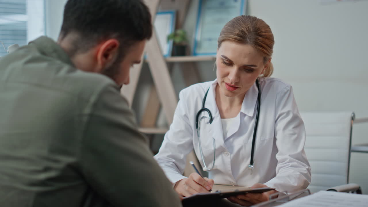 Medical worker discussing symptoms with patient closeup. Smiling doctor explain