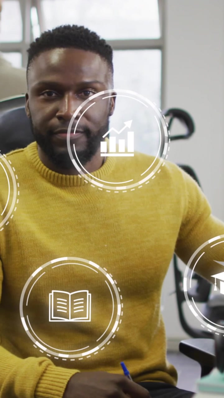 Animation of icon in circles over african american man working in office