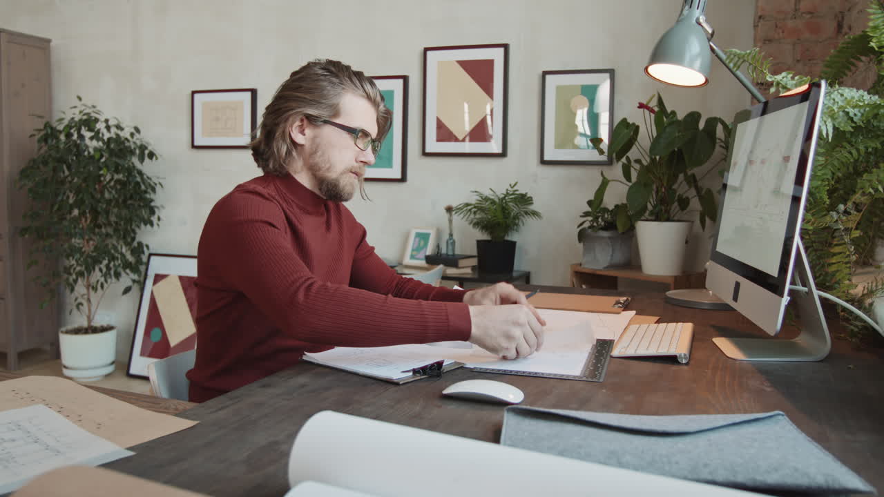 Male Architect Drawing Sketches Of New House