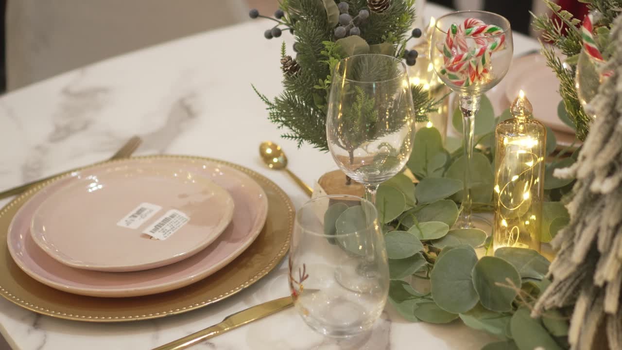 Close-up of an elegant festive table with warm decorations and Christmas lighting. 4k.