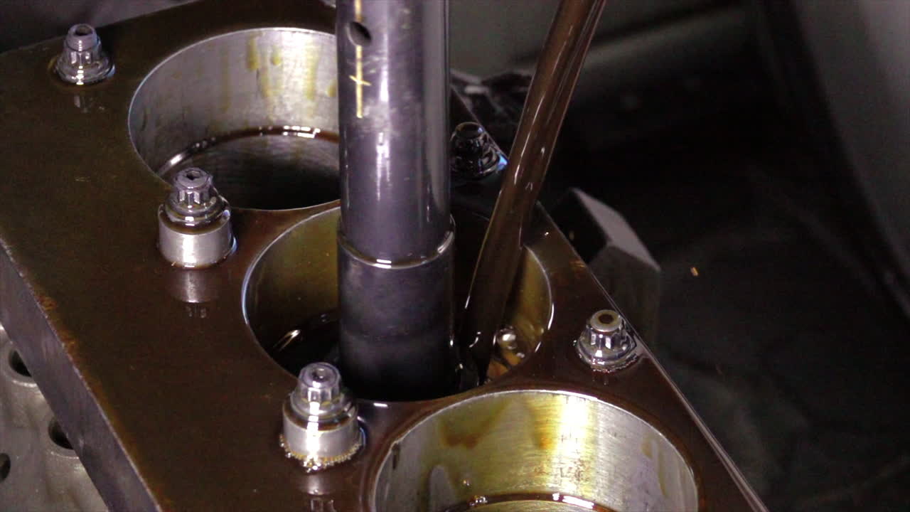 Changing Engine Oil: Close-up of Oil Being Poured into Engine