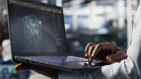 close up of data center worker using laptop to interpret ai data analytics