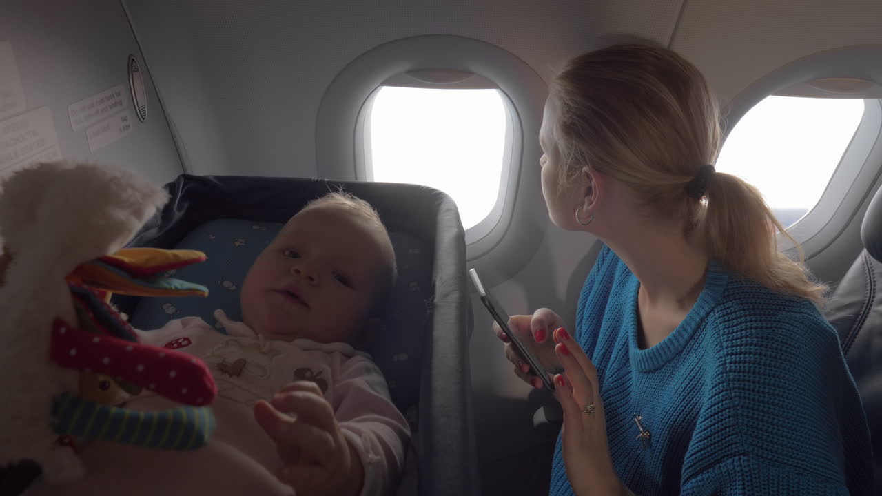 Baby in a cot on an airplane