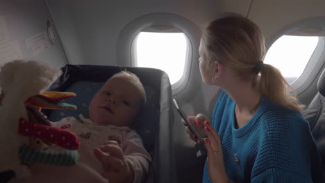 baby in a cot on an airplane