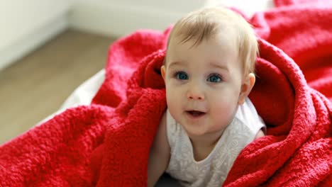 Cute-baby-girl-on-bed-in-bedroom