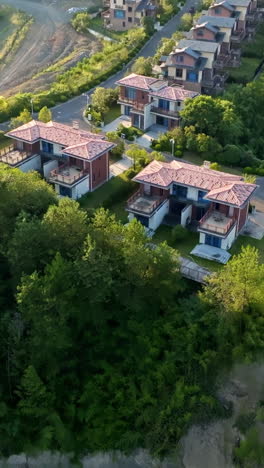 vertical drone shot tilting in front of neighborhood homes, golden hour in china