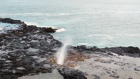 HD-Slow-motion-Hawaii-Kauai-static-center-frame-Spouting-Horn-blowhole,-part-one-of-two