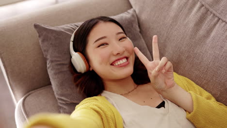 top view, selfie and asian woman on couch