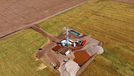 distancing from the site producing natural resources. high white tower with drilling equipment in the middle. aerial perspective.