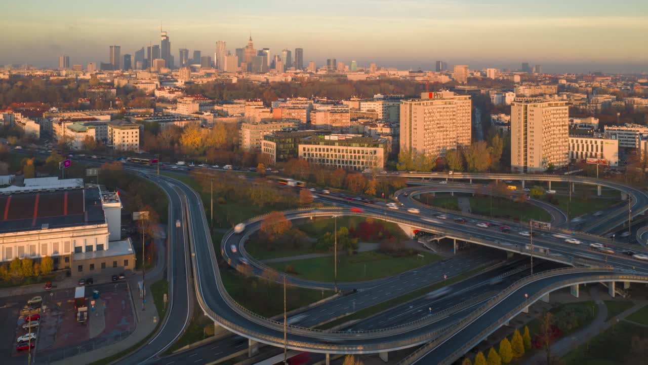 Aerial hyperlapse of Warsaw skyline with fast cars on Trasa Lazienkowska