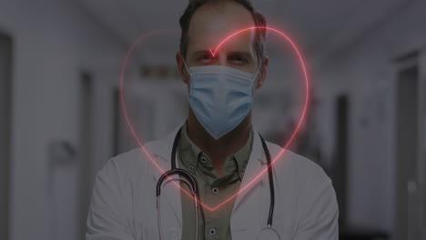 animation of neon heart over caucasian male doctor with face mask