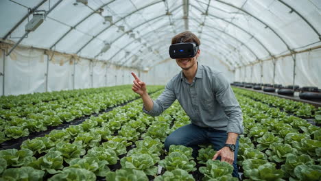 man using vr headset to monitor plants in a greenhouse