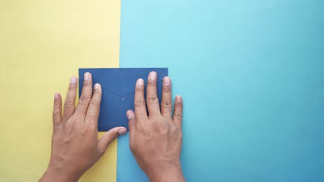 person hand putting cash in a envelope