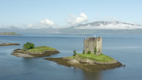 an aerial view of castle stalker on loch laich on a sunny morning