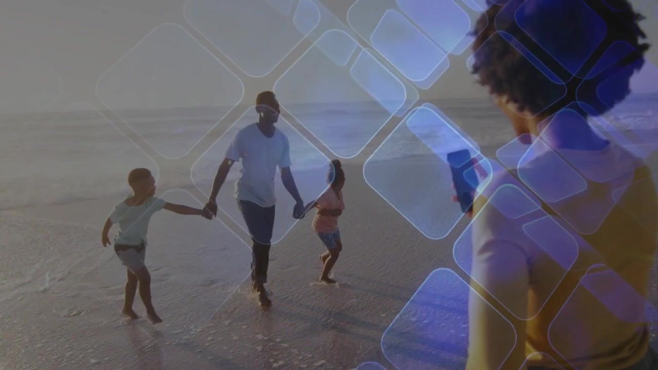 Woman raising smartphone and documenting family walking on shoreline, tech AR grid overlaying scene