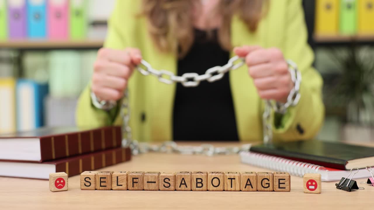 Self-sabotage concept with businesswoman chained