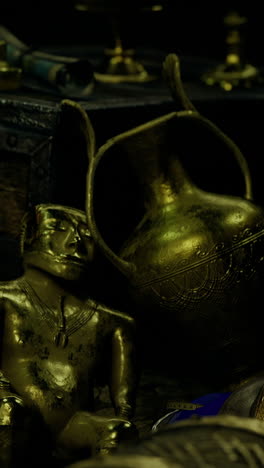 ancient treasures shine in a dimly lit room filled with artifacts