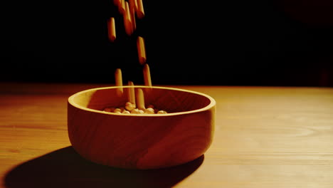 chickpeas falling into a wooden bowl