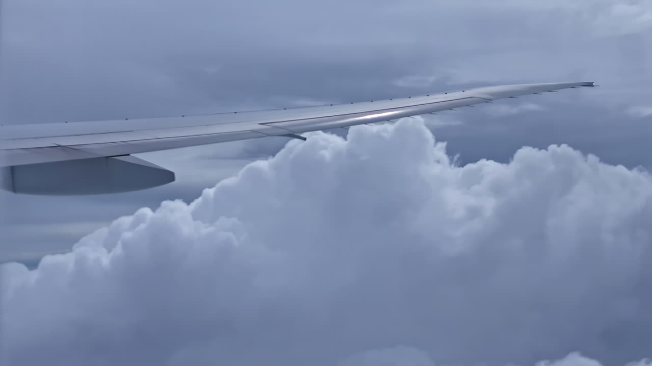 Aircraft wing captured mid-flight with blue sky in background