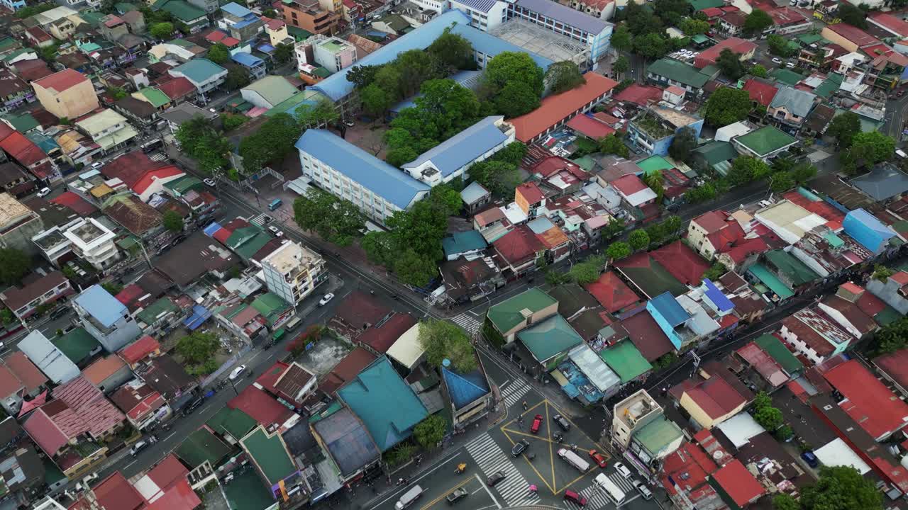 Overhead drone shot of streets, house rooftops, and buildings at densely populated Marikina City, Philippines.
