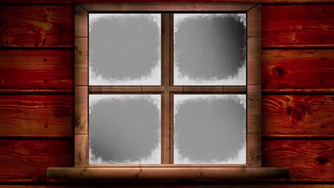 wooden retro window frame over snow falling against black background