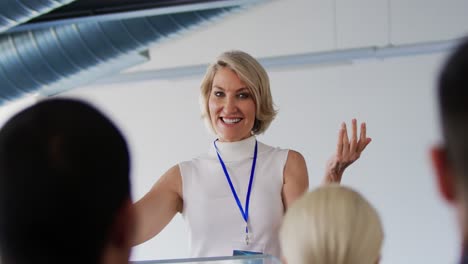 female speaker addressing the audience at a business conference