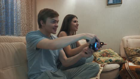 teenagers playing video games at home