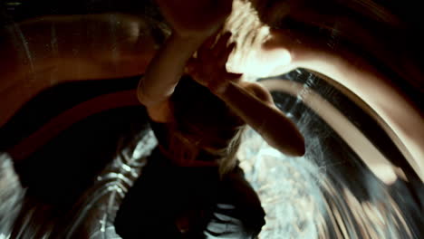 female dancer making hand movements among distorted reflections