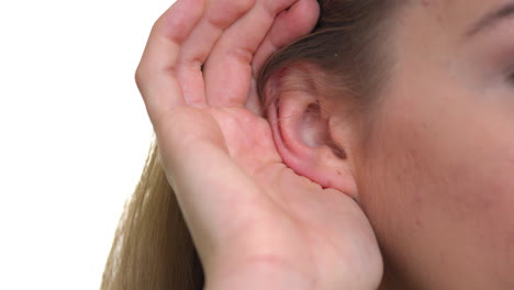 the woman puts her hand to her ears to hear and overhear something better