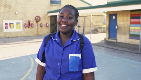 Portrait-of-a-young-schoolgirl-smiling-in-playground-4k