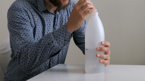 person using bubble pep device bottle blowing to remove excess mucus and phlegm