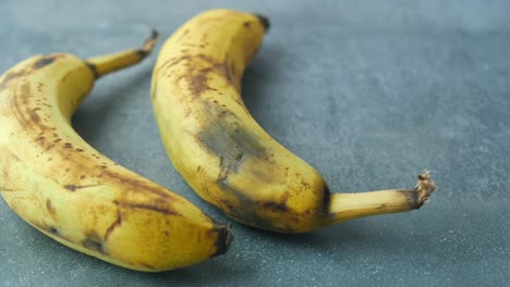 overripe bananas on a gray surface