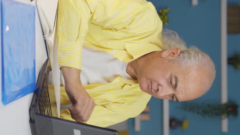 Vertical-video-of-Home-office-worker-old-man-completes-his-work-and-relax.