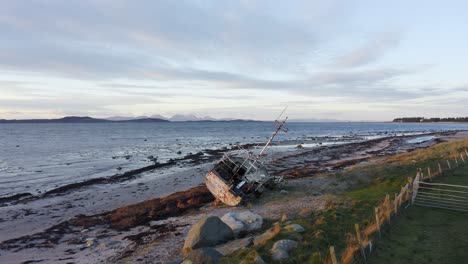 aerial - shipwreck on a beach, kintyre, scotland, pan left