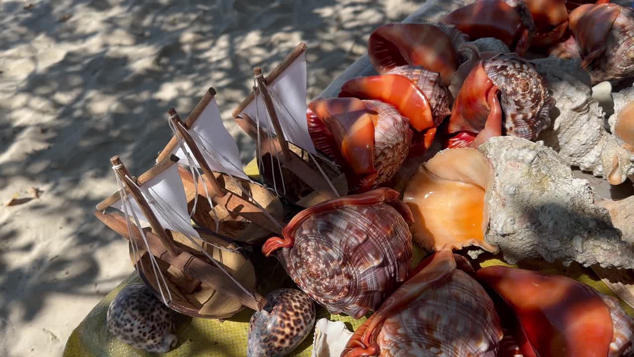 Souvenir counter with seashells and wooden toy sailboats. Zanzibar, Tanzania.