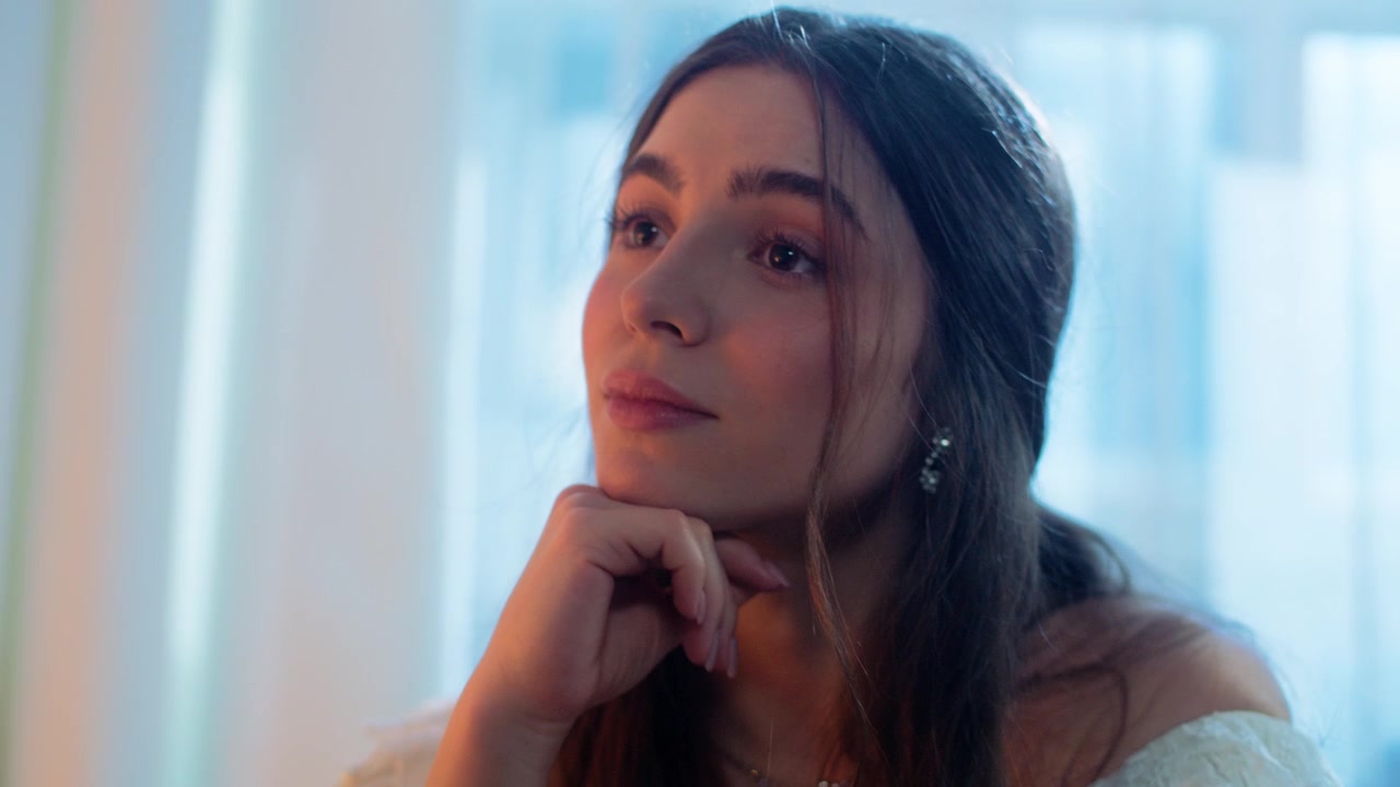 Thoughtful Young Woman Sitting at an Elegant Dinner Table