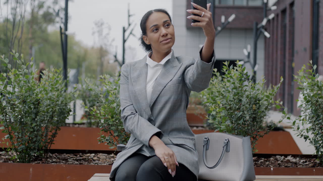 Businesswoman Taking a Selfie in the City Park