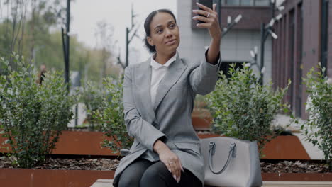 businesswoman taking a selfie in the city park