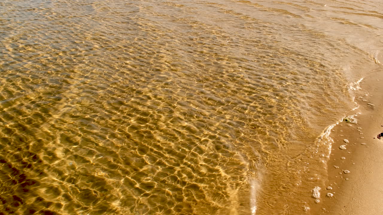 Clear Rippling Water on a Sandy Beach Shore