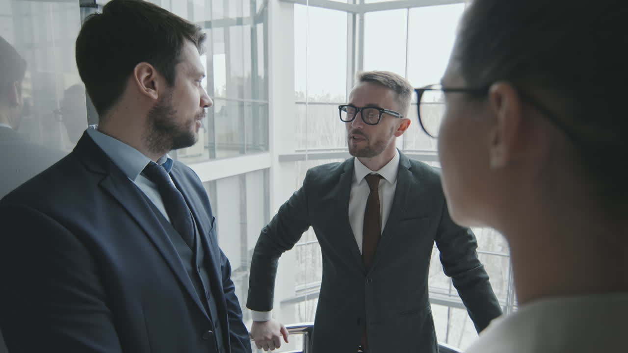 Team of Lawyers Talking in Elevator