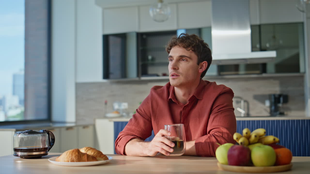 Calm man drinking espresso alone at home feeling relaxed closeup. Pensive guy