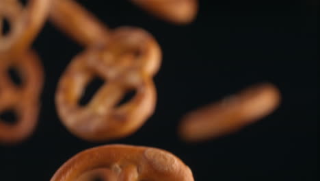 pretzels flying on the black background in macro and slow motion