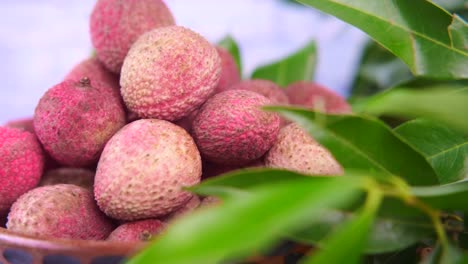 pile of pink lychees in a bowl