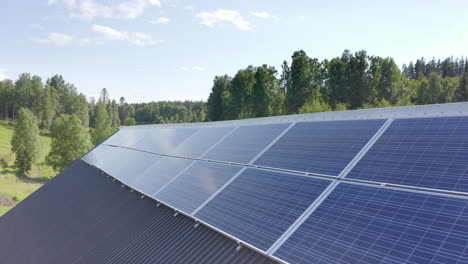 solar array installed neatly on rooftop of building in countryside, aerial